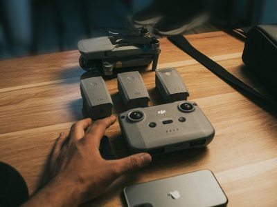 pexels-photo-12504497-12504497 Drone Parts and Camera over a Wooden Table